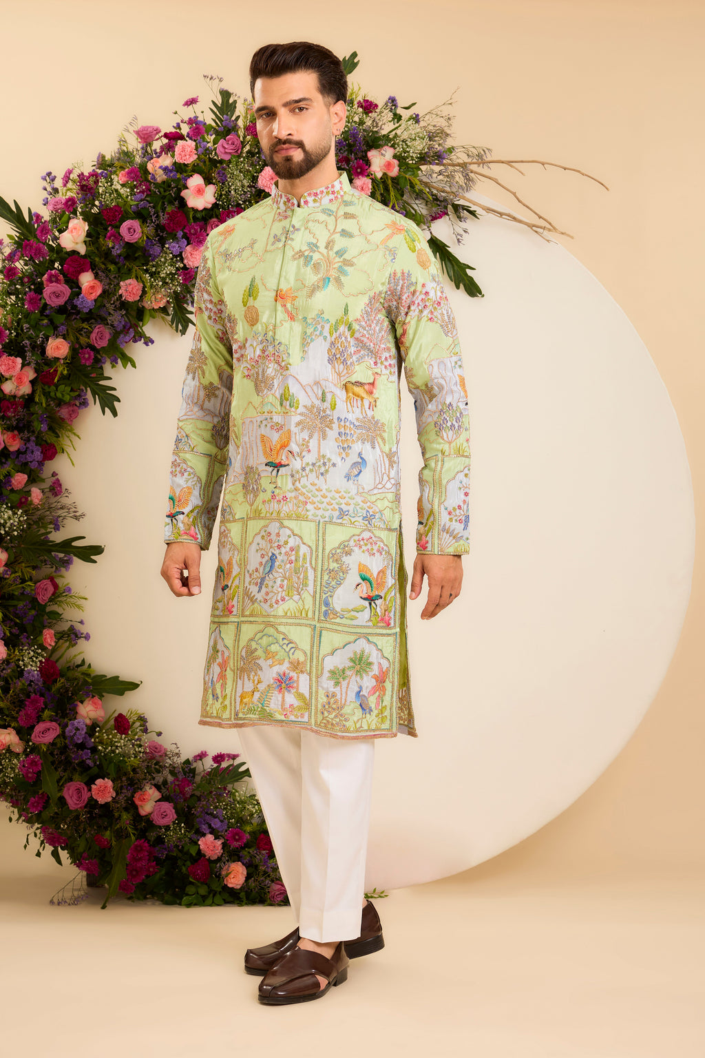 A Vibrant green Crepe Kurta Richly Embroidered with Wildlife